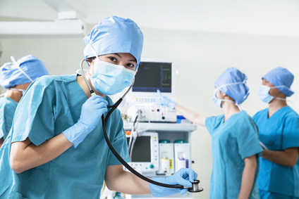 Team of surgeons in the operating room, female surgeon holding