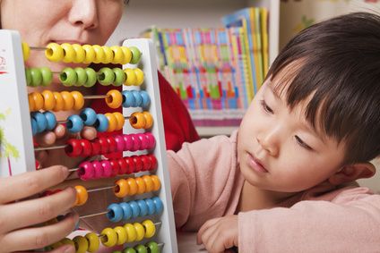 Boy Playing with Abacus
